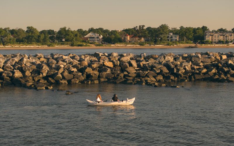 Kayak in front of oyster reef looking to shore.